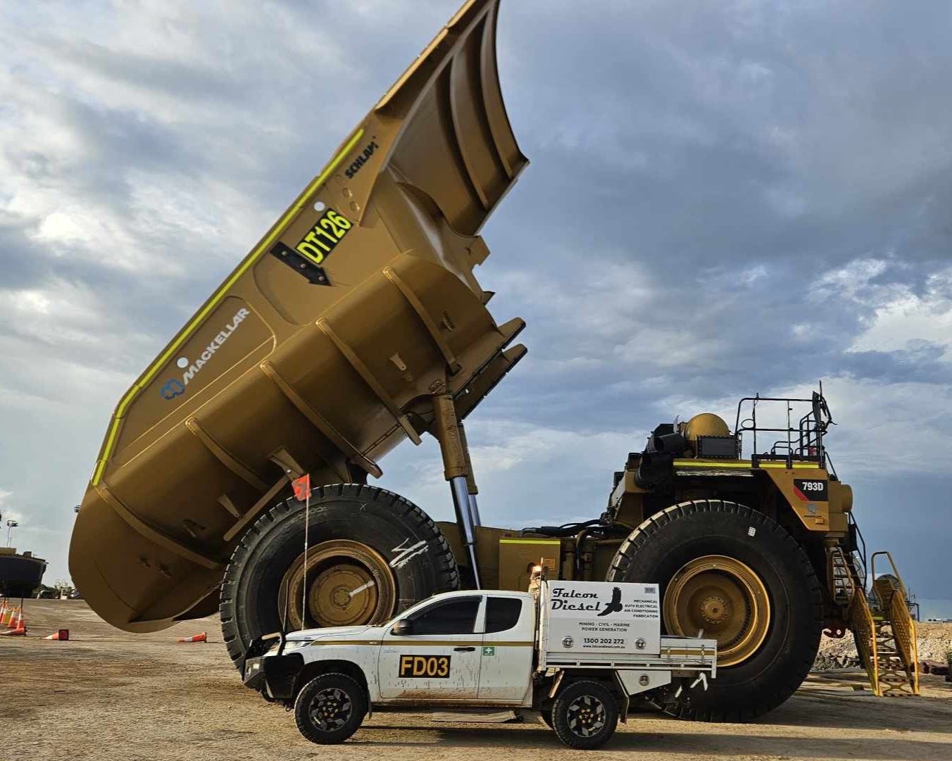 Rigid haul truck shut down on a mine hardstand for engine diagnostics and repair