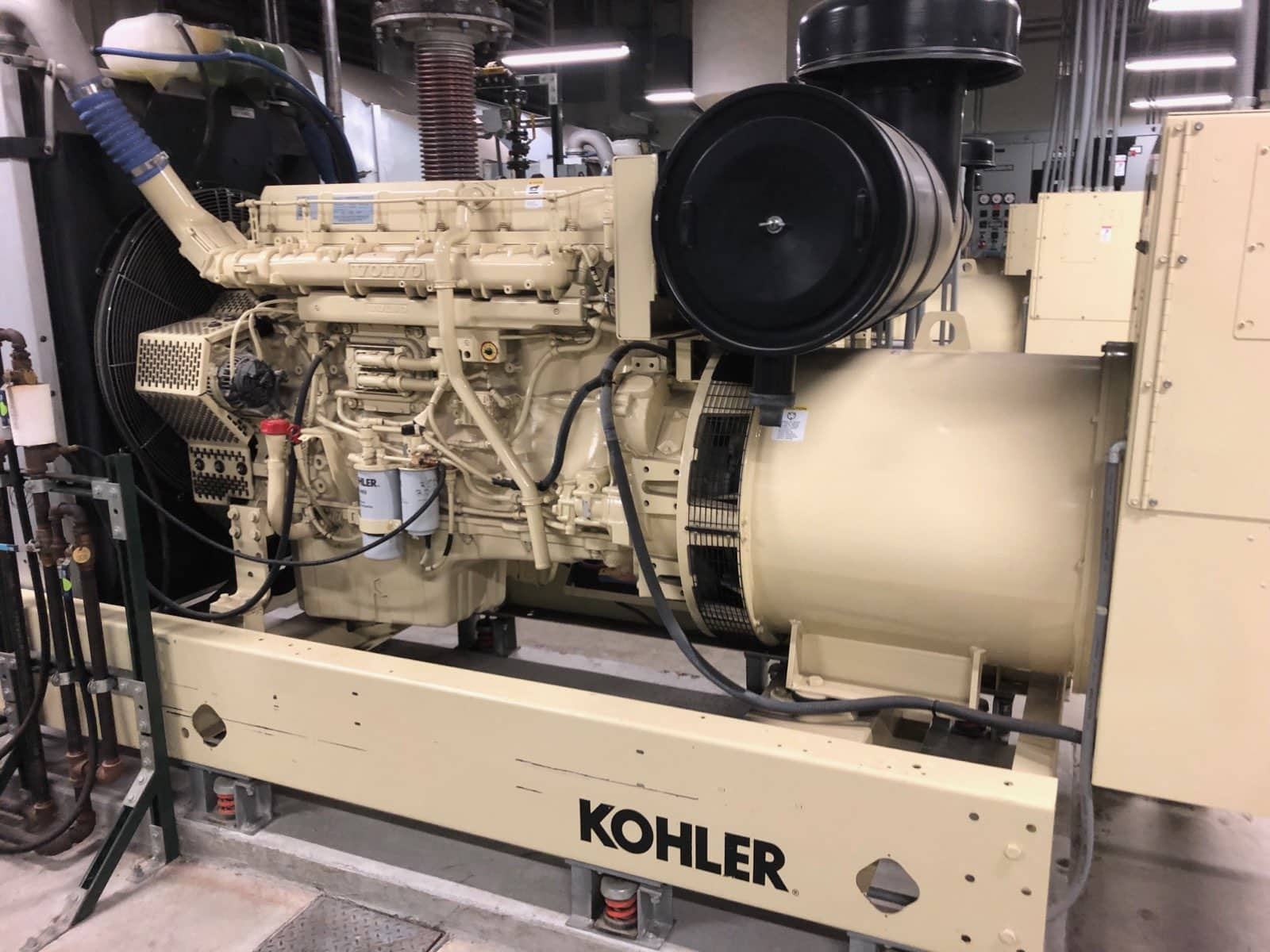 A cream Kohler diesel generator set with a Volvo engine, installed in an indoor plant room